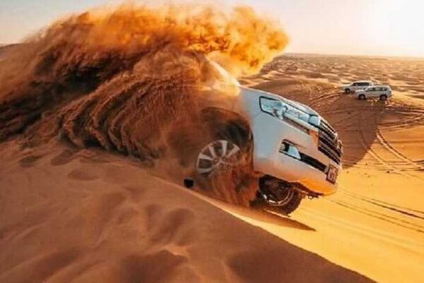 "4x4 vehicle dune bashing on red dunes in the desert"