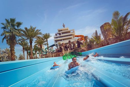 "Riders enjoying a high-speed water coaster at Atlantis Aquaventure"